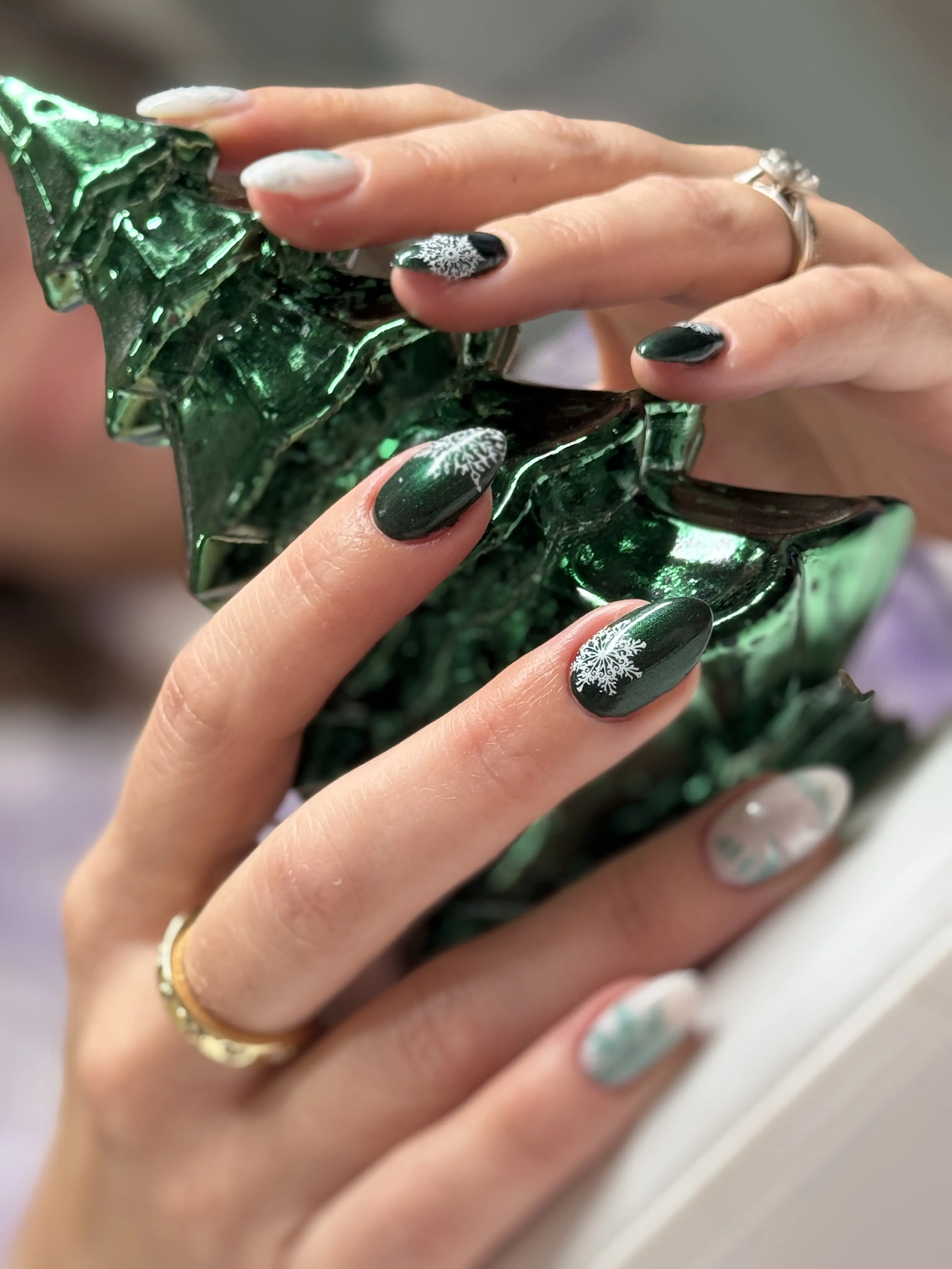 Christmas-themed nail design with festive green and gold accents
