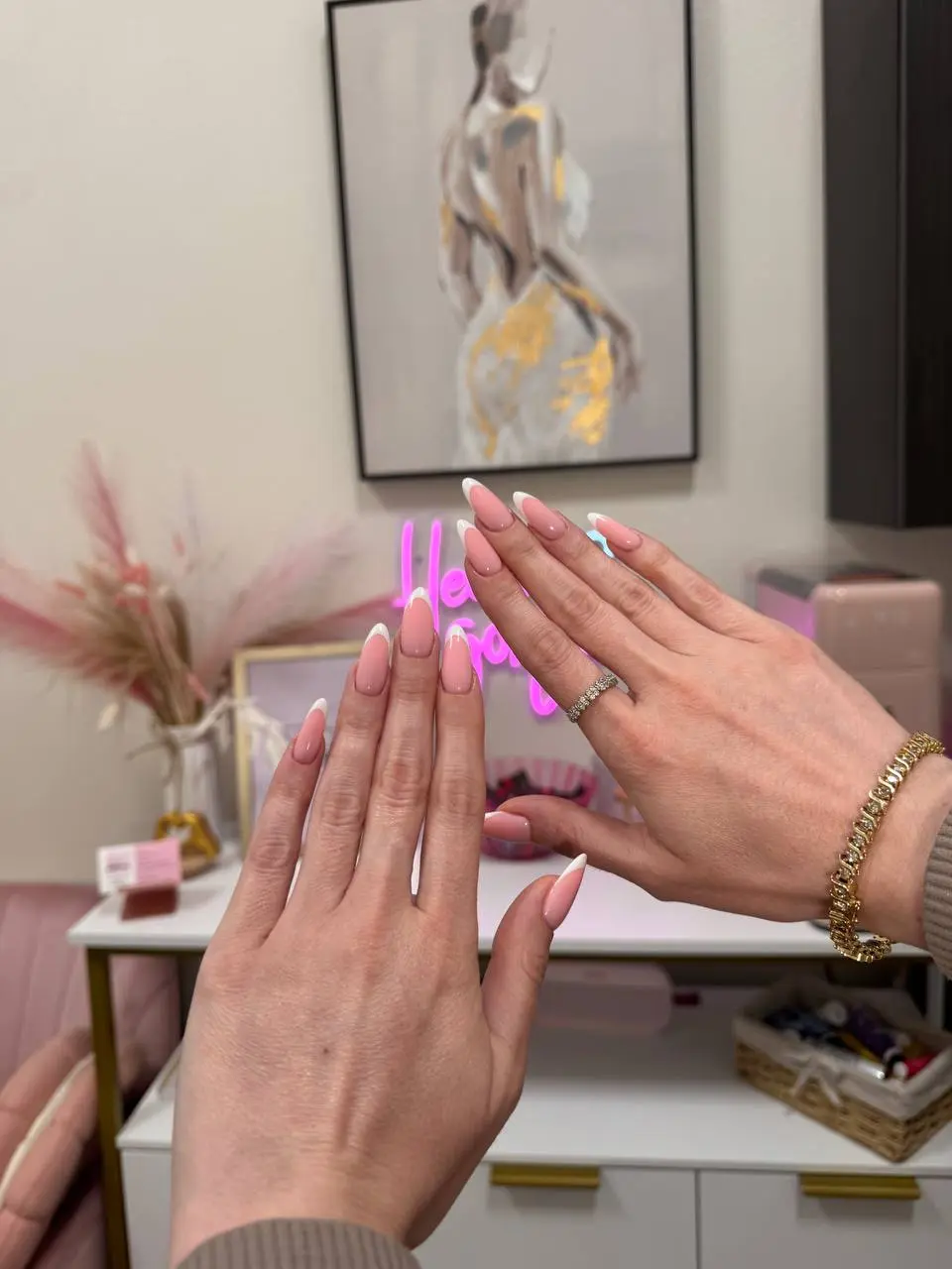 Short nails with French ombré gradient design and neon studio backdrop