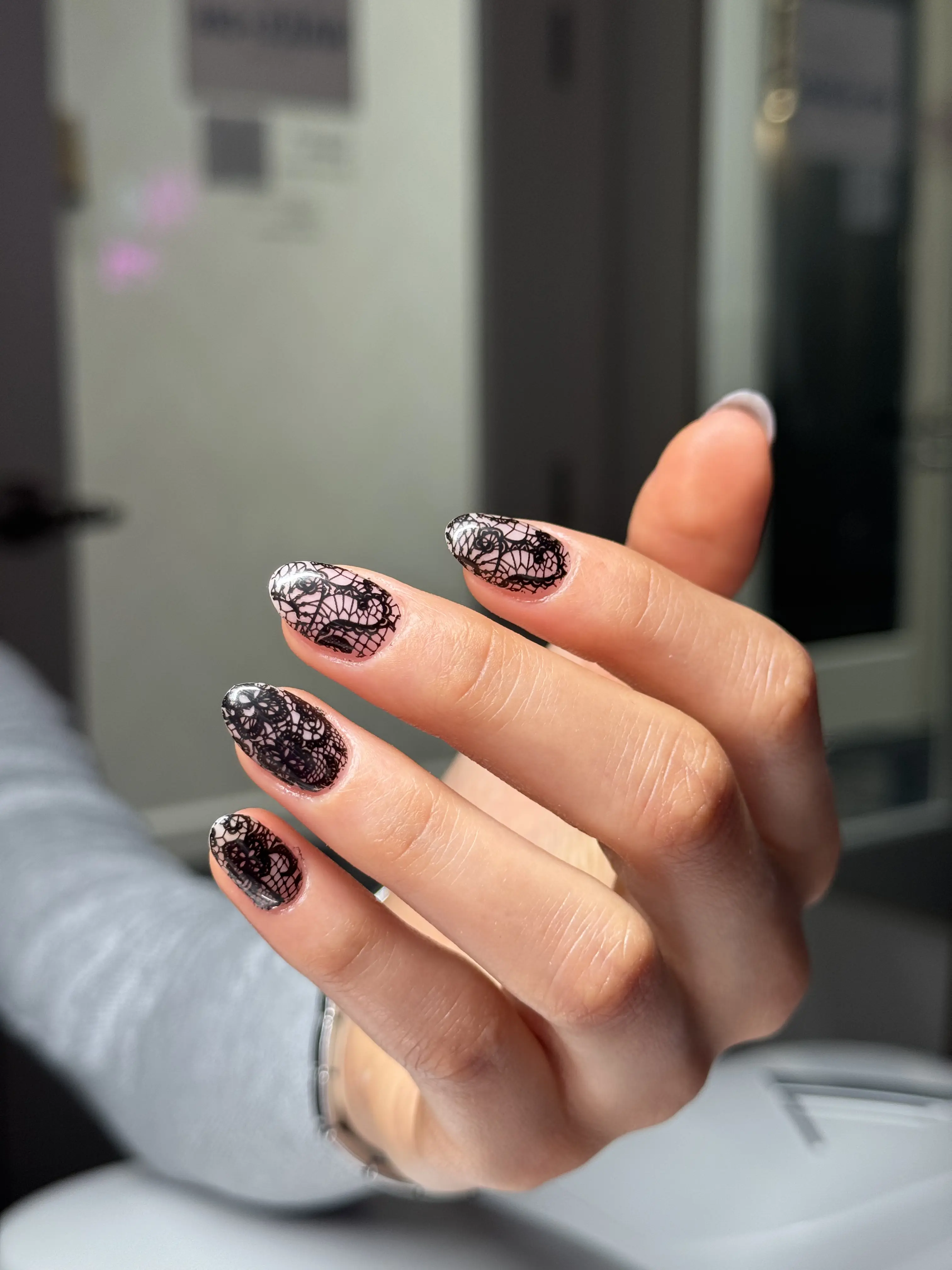 Black lace nail art design showing detailed artistry