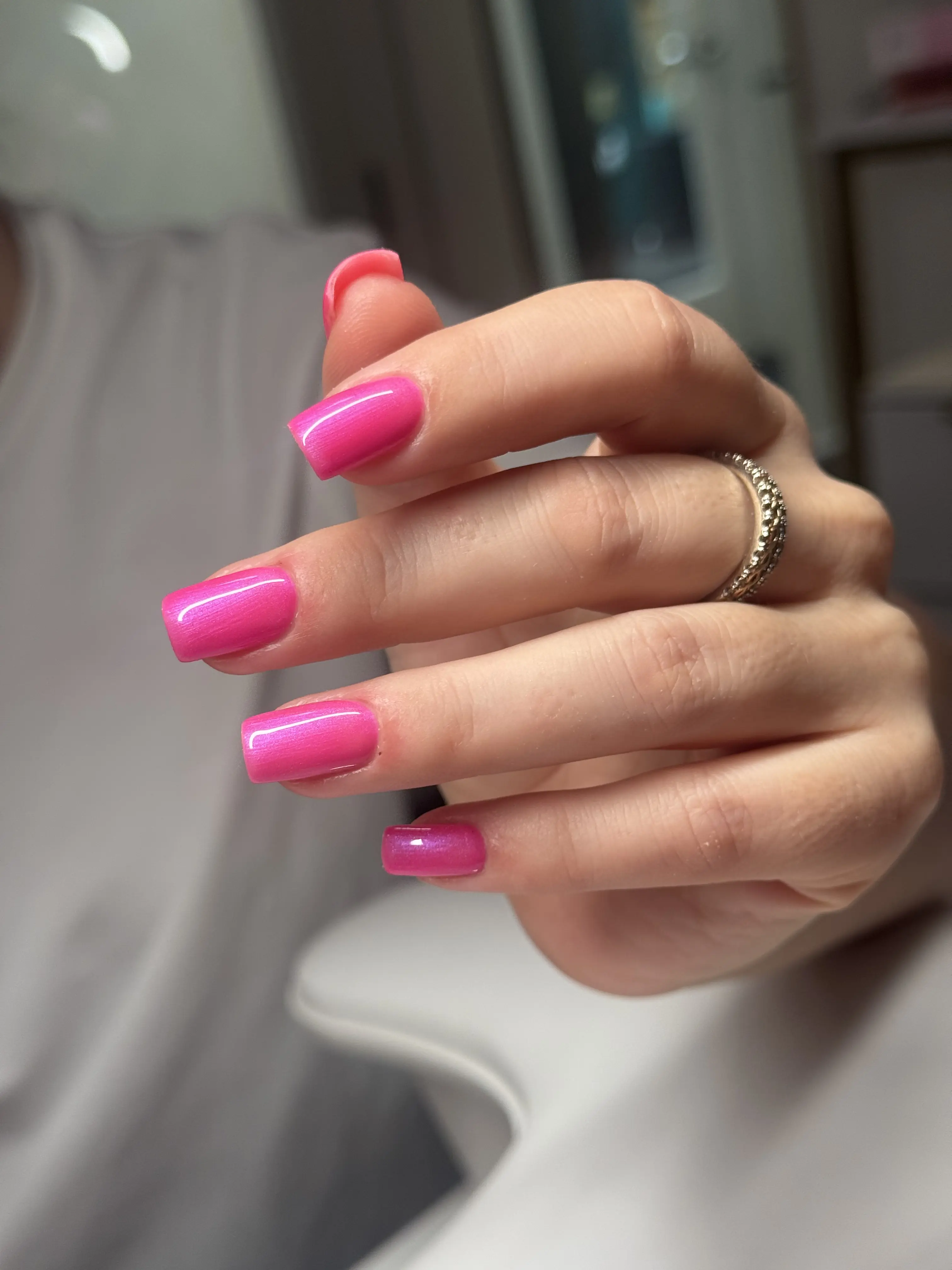 Hot pink nails from alternate angle showing shine and dimension